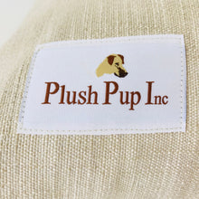 Load image into Gallery viewer, Plush Pup Inc logo on tag, pictured on a dog bed cover