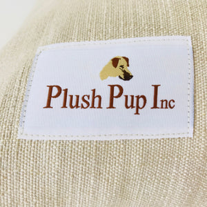 Plush Pup Inc logo on tag, pictured on a dog bed cover